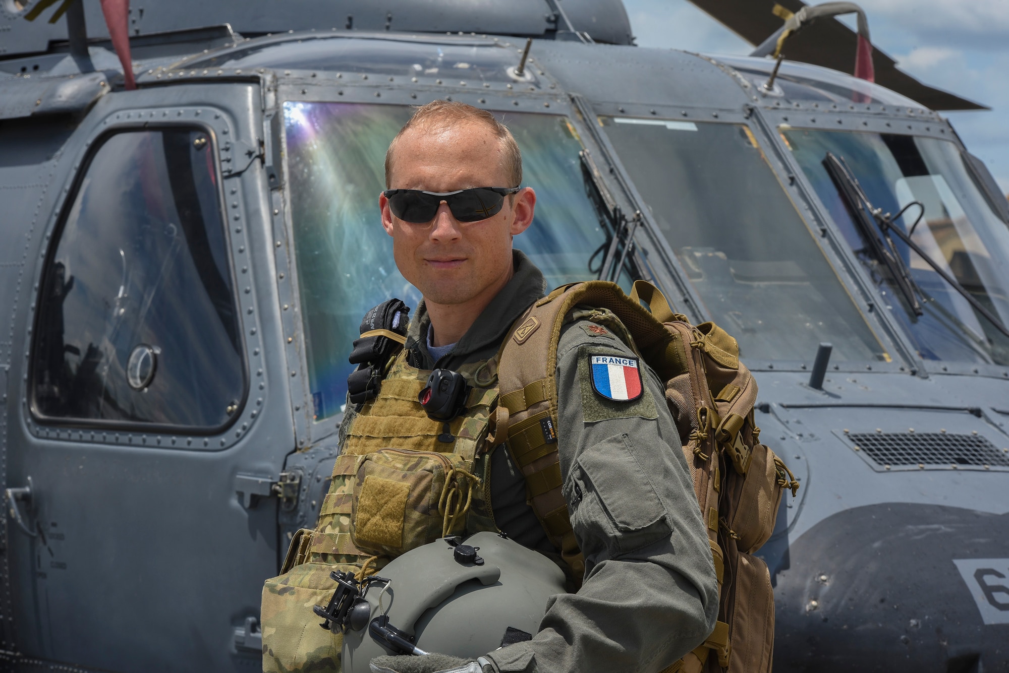 Commandant Micka, a French exchange pilot and assistant director of operations for Moody’s 41st Rescue Squadron, stands in front of an HH-60G Pavehawk, Aug. 2, 2017, at Moody Air Force Base, Ga. Prior to his arrival at the 41st RQS, Micka transitioned from flying the French Air Force’s EC-725 Caracal helicopter to learn the HH-60. Since his childhood, Micka aspired to serve and fly for the French and U.S. military as a rescue pilot. (U.S. Air Force photo by Senior Airman Greg Nash)