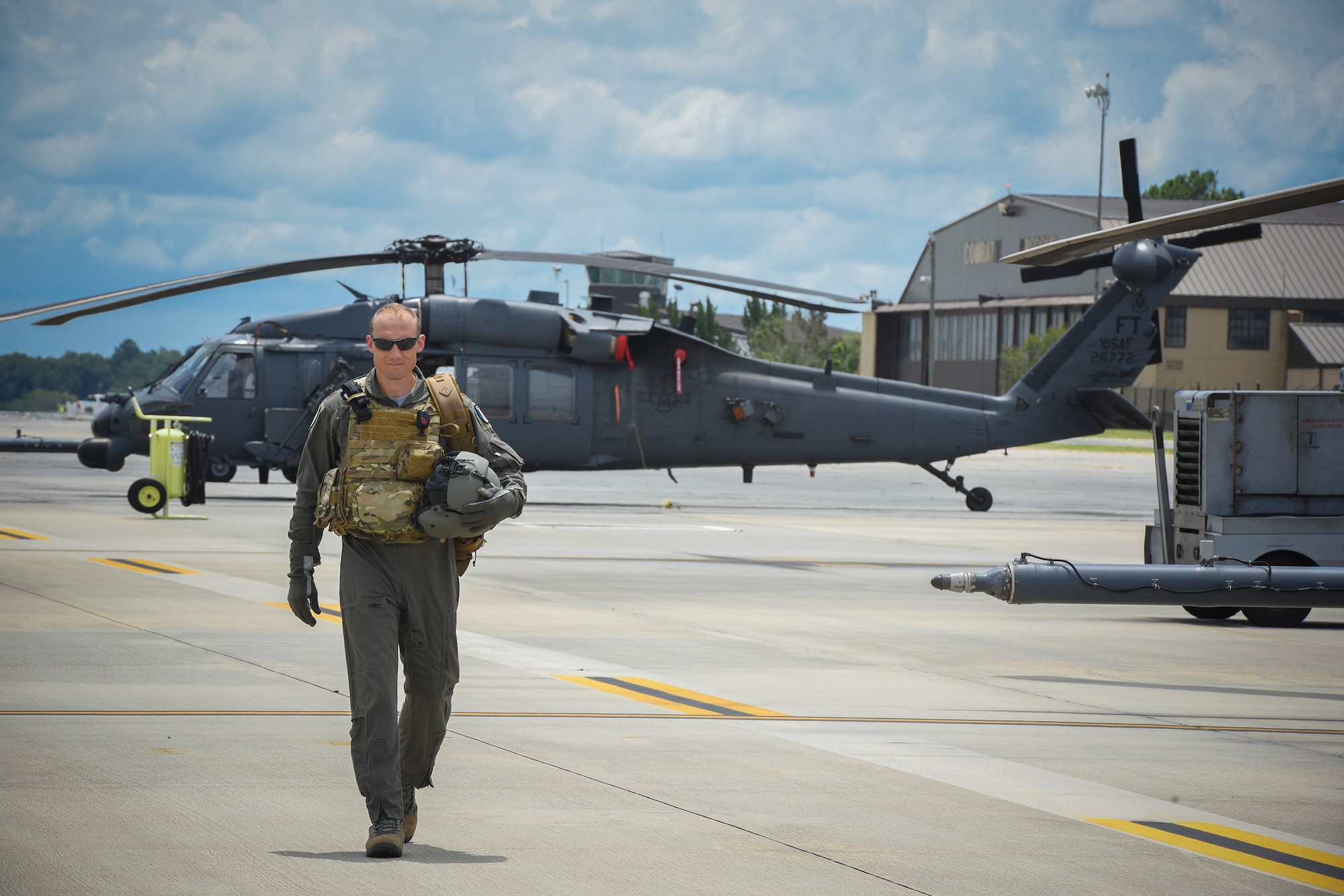 Commandant Micka, a French exchange pilot and assistant director of operations for Moody’s 41st Rescue Squadron, walks on the flightline past an HH-60G Pavehawk, Aug. 2, 2017, at Moody Air Force Base, Ga. Prior to his arrival at the 41st RQS, Micka transitioned from flying the French Air Force’s EC-725 Caracal helicopter to learn the HH-60. Since his childhood, Micka aspired to serve and fly for the French and U.S. military as a rescue pilot. (U.S. Air Force photo by Senior Airman Greg Nash)