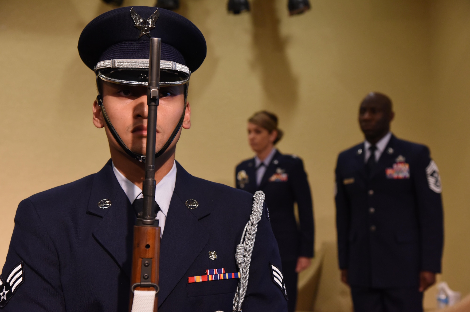 Senior Airman Anthony Balancio, Keesler Honor Guard member, presents the colors during a retirement ceremony for Chief Master Sgt. Vegas Clark, 81st Training Wing command chief, in the Bay Breeze Event Center Aug. 11, 2017, on Keesler Air Force Base, Miss. Clark retired with 22 years of military service. Prior to his assignment at Keesler he served as the command chief for the 39th Air Base Wing, Incirlik Air Base, Turkey. (U.S. Air Force photo by Kemberly Groue)