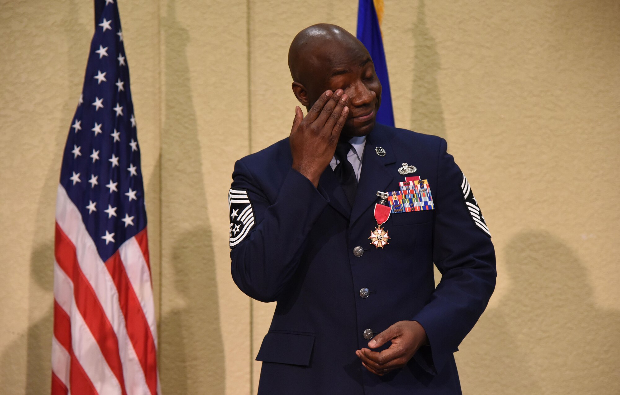 Chief Master Sgt. Vegas Clark, 81st Training Wing command chief, wipes his eye during his retirement ceremony in the Bay Breeze Event Center Aug. 11, 2017, on Keesler Air Force Base, Miss. Clark retired with 22 years of military service. Prior to his assignment at Keesler he served as the command chief for the 39th Air Base Wing, Incirlik Air Base, Turkey. (U.S. Air Force photo by Kemberly Groue)