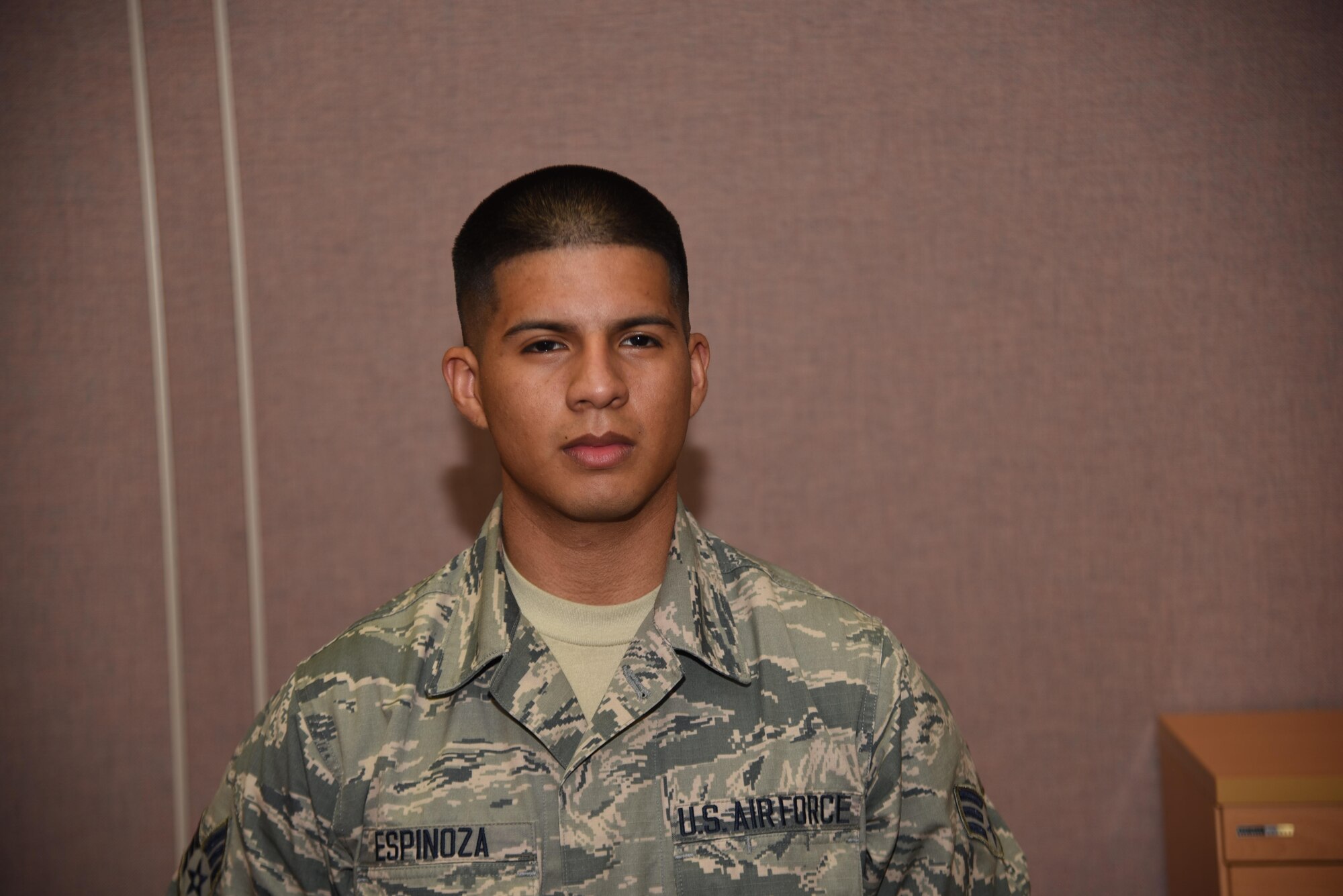SrA Joseph Espinoza, Personnelist, 108th Maintenance Squadron poses for a photo in the personnel section July 19, 2017. Front and center highlights a 108th Wing airman every month. (U.S. Air National Guard photo by Staff Sgt. Ross A. Whitley/Released)