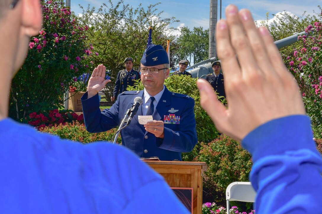 914th Air Refueling Wing Commander, Col. Brian S. Bowman, administers the Oath of Enlistment to Air Force Reserve recruits at the 2017 Erie County Fair.