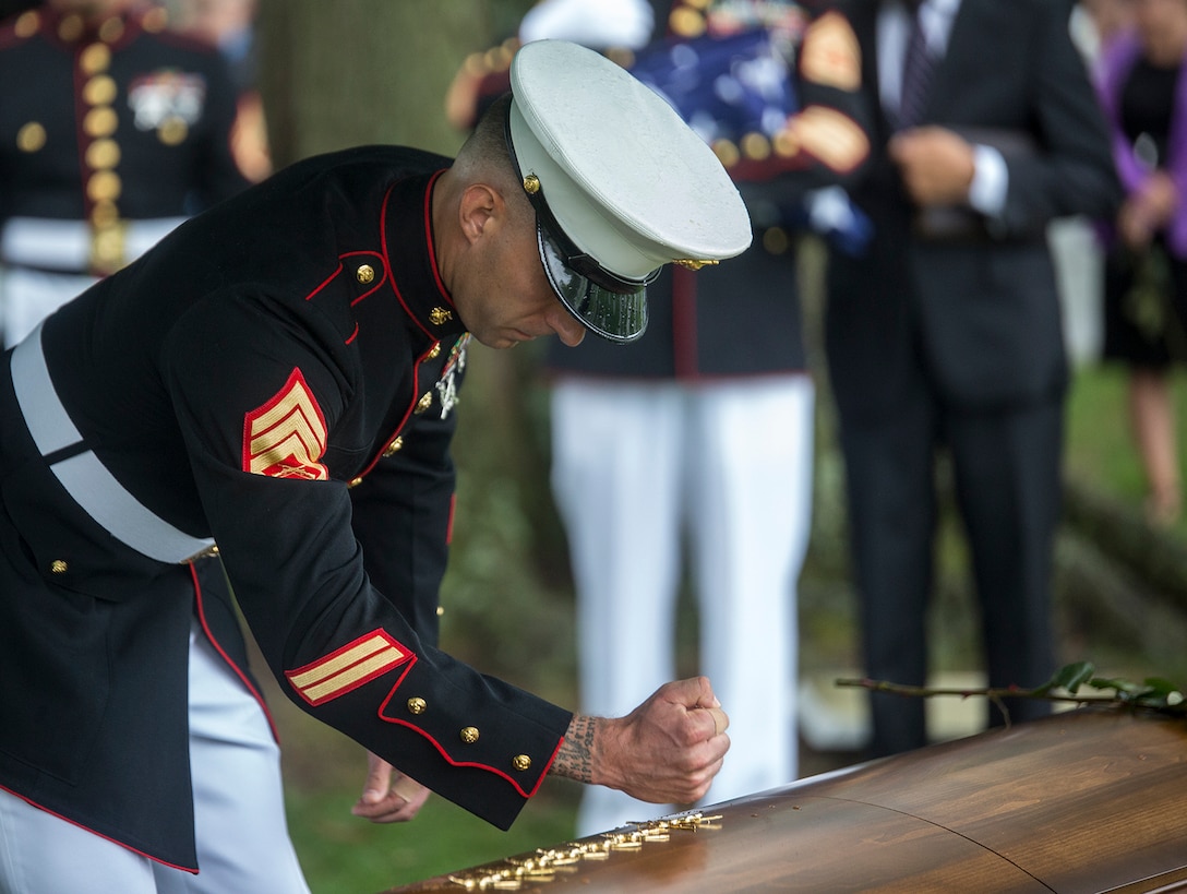 A Marine Staff Sgt. pounds his Marine Special Operator Insignia into the casket of fallen Marine Sgt. Joseph J. Murray during a funeral for Murray at Arlington National Cemetery, Arlington, Va., Aug. 15, 2017. Murray, 26, was one of the 15 Marines and one Navy sailor who perished when their KC130-T Hercules crashed in Mississippi, July 10, 2017. Murray was a Critical Skills Operator with the 2nd Raider Battalion, Marine Corps Forces Special Operations Command (MARSOC). It is tradition in the Special Operations community for fellow members of the fallen veteran’s unit to pound their insignia into the casket as a sign of never leaving their side and a final show of respect. (Official U.S. Marine Corps photo by Cpl. Robert Knapp/Released)