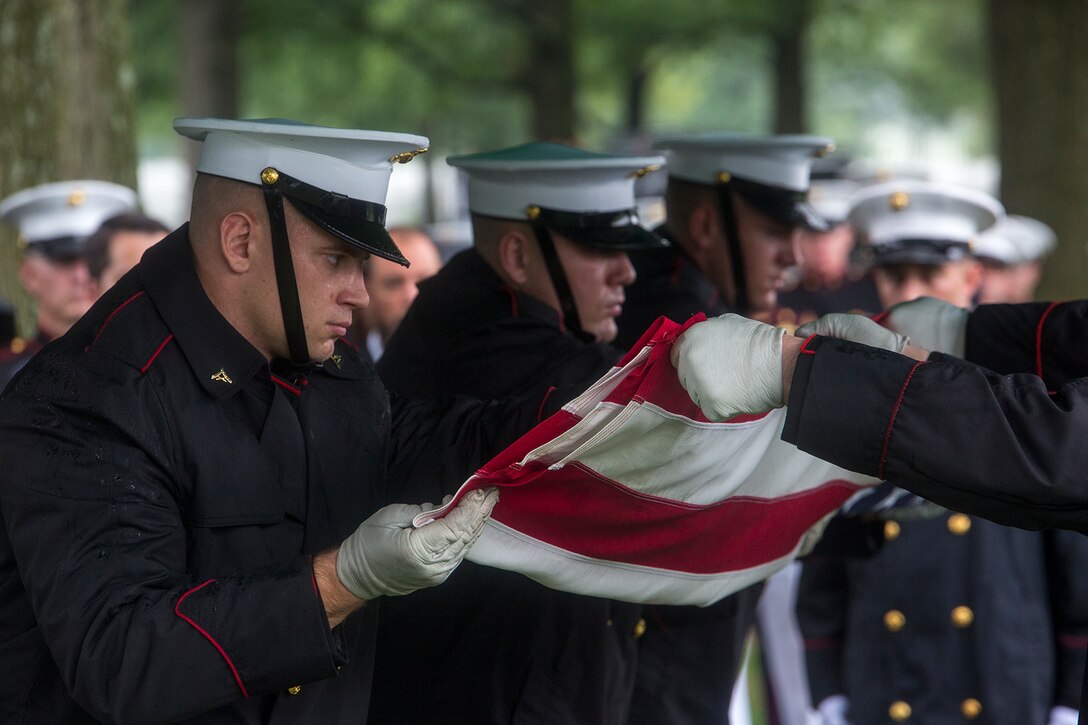 Marine Corps Body Bearers with Bravo Company, Marine Barracks Washington D.C., fold the National Ensign during a funeral for Marine Sgt. Joseph J. Murray at Arlington National Cemetery, Arlington, Va., Aug. 15, 2017. Murray, 26, was one of the 15 Marines and one Navy sailor who perished when their KC130-T Hercules crashed in Mississippi, July 10, 2017. Murray was a Critical Skills Operator with the 2nd Raider Battalion, Marine Corps Forces Special Operations Command (MARSOC). (Official U.S. Marine Corps photo by Cpl. Robert Knapp/Released)