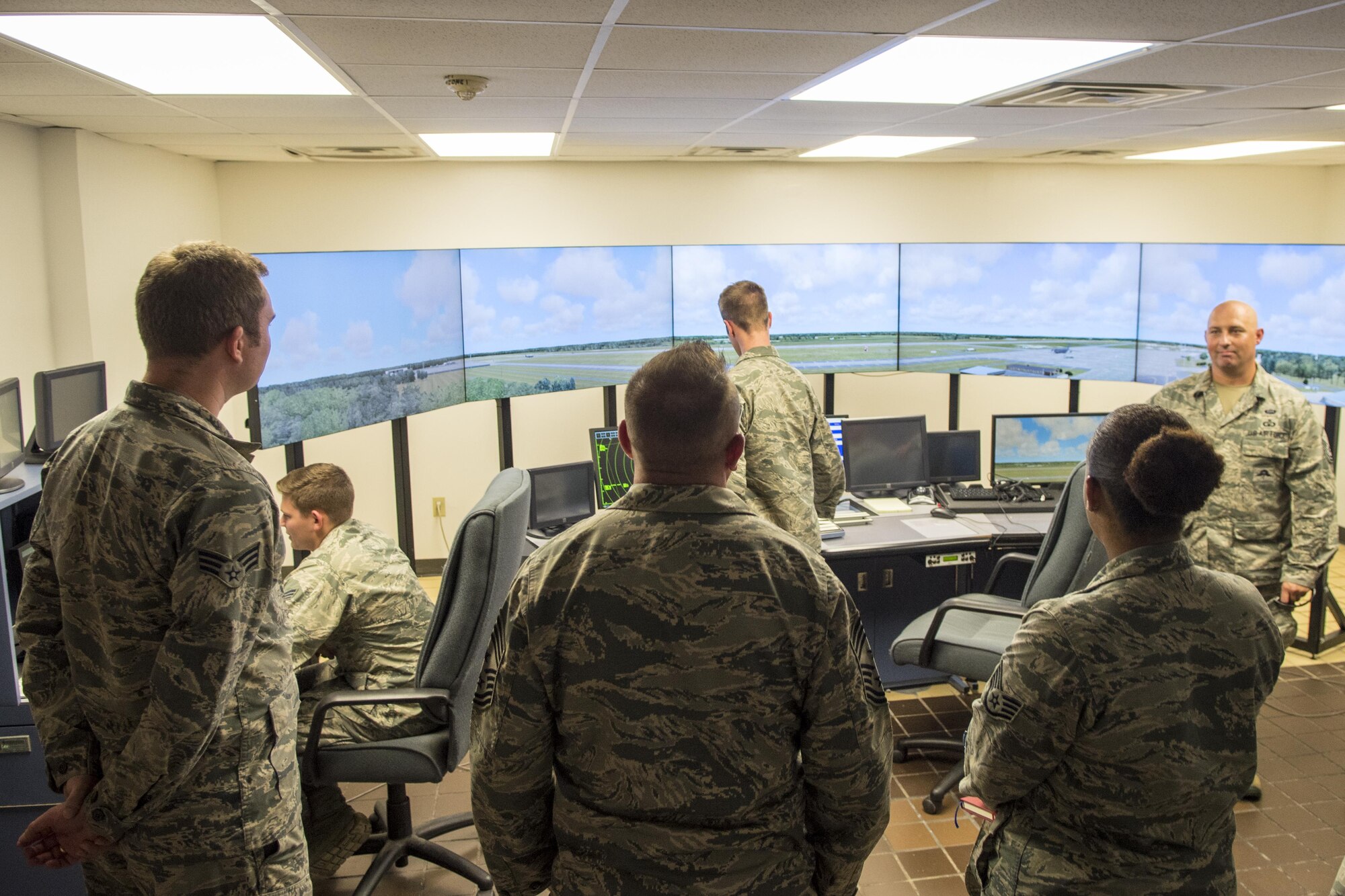 U.S. Air Force Chief Master Sgt. David Wade, center, 9th Air Force command chief, visits the air traffic control training simulator, Aug. 14, 2017, at Seymour Johnson Air Force Base, N.C. Airmen from the 4th Operational Support Squadron air traffic control use the simulator to continue training after technical school and maintain proficiency while supporting the Team Seymour mission in the air traffic control tower. (U.S. Air Force photo by Airman 1st Class Shawna L. Keyes)
