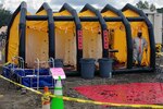 A Soldier with the 64th Civil Support Team, New Mexico Army National Guard, sets up the mass decontamination shower as part of a training scenario for the Vigilant Guard exercise Aug. 8 in Lamy, N.M. This decontamination site was part of a train derailment scenario that spilled hazardous waste injuring more than 100 role players.