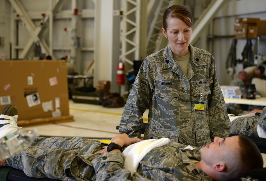 Lt. Col. Catherine Bonhoff, 375th Aeromedical Evacuation Squadron Director of Operations, talks with a simulated patient during Exercise Mobility Guardian at Joint Base Lewis-McChord, Wash.