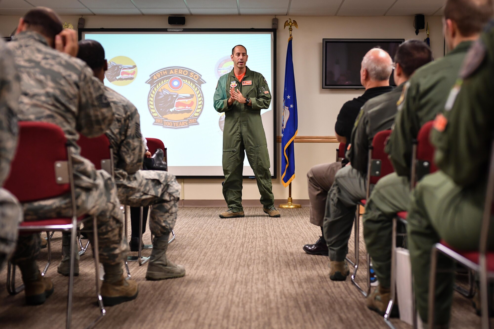 Lt. Col. Joseph McKenna, 49th Test and Evaluation Squadron commander, speaks to guests during a ceremony at Barksdale Air Force Base, La., Aug. 2, 2017. The ceremony was held to celebrate the 100th birthday of the 49th TES, and to provide a historical overview of the unit’s missions and accomplishments over the century. (U.S. Air Force Photo/Senior Airmen Mozer O. Da Cunha)