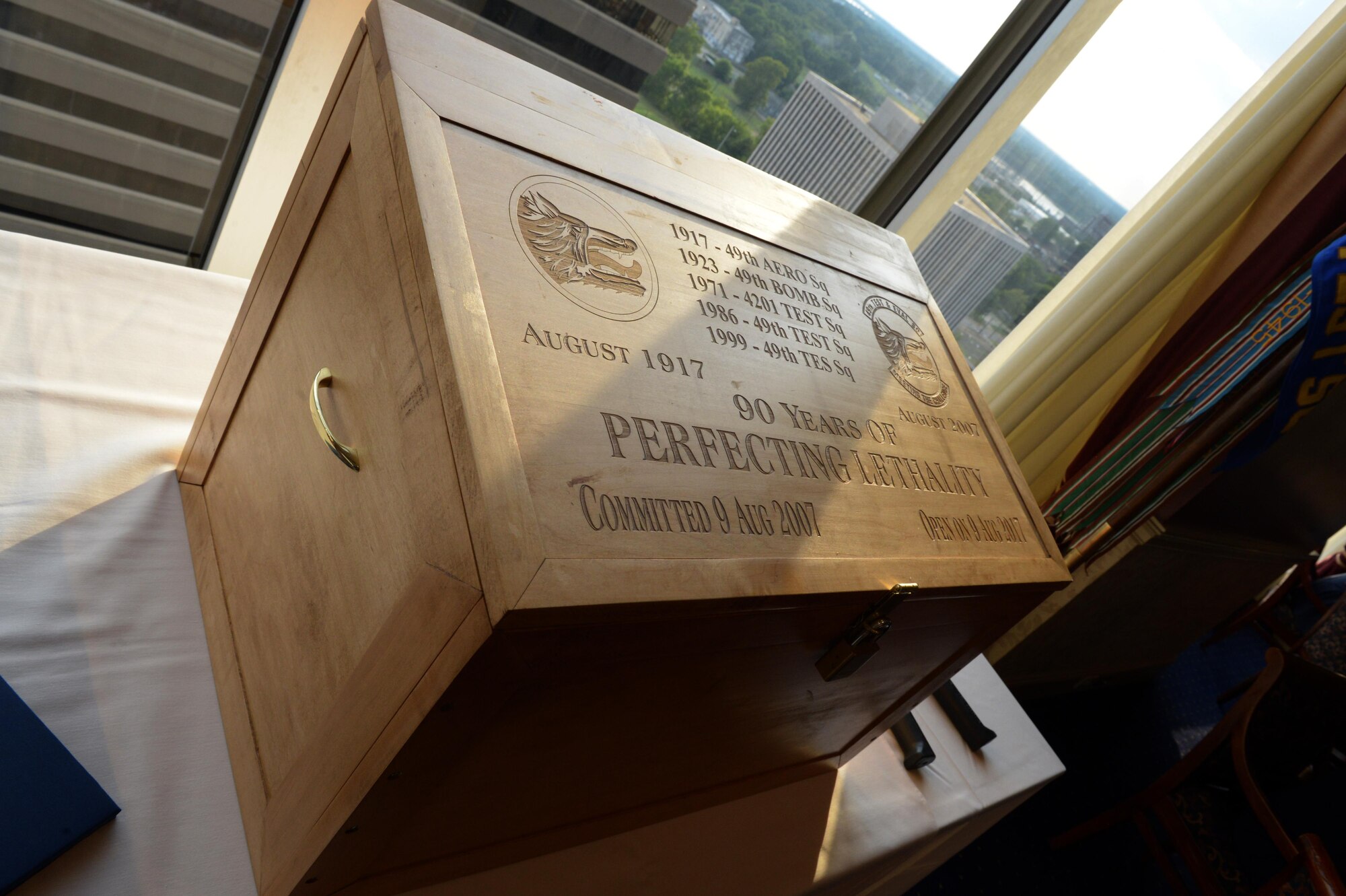 A time capsule honoring the 49th Test and Evaluations Squadron is displayed at the Petroleum Club in Shreveport, La., Aug. 5, 2017. The capsule was created and put together by members of the 49th TES on Aug. 9, 2007, with instructions to be opened on its 100th birthday. (U.S. Air Force Photo/Senior Airman Curt Beach)