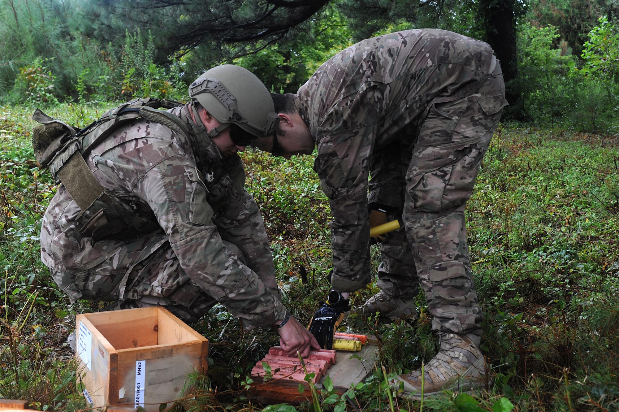 U.S. Air Force Tech. Sgt. Marc Rowand-Donohue, 633rd Civil Engineer Squadron Explosives Ordinance Disposal team lead and Senior Airman Christopher Armantrout, 633rd Civil Engineer Squadron EOD team member, participate in a simulated unexploded ordnance evaluation training during Operation Llama Fury 3.0 at Joint Base Langley-Eustis, Va., Aug. 8, 2017. The UXO scenario allowed the teams to properly identify the threat and how to dispose of it within regulations. (U.S. Air Force photo/Staff Sgt. Brittany E. N. Murphy)