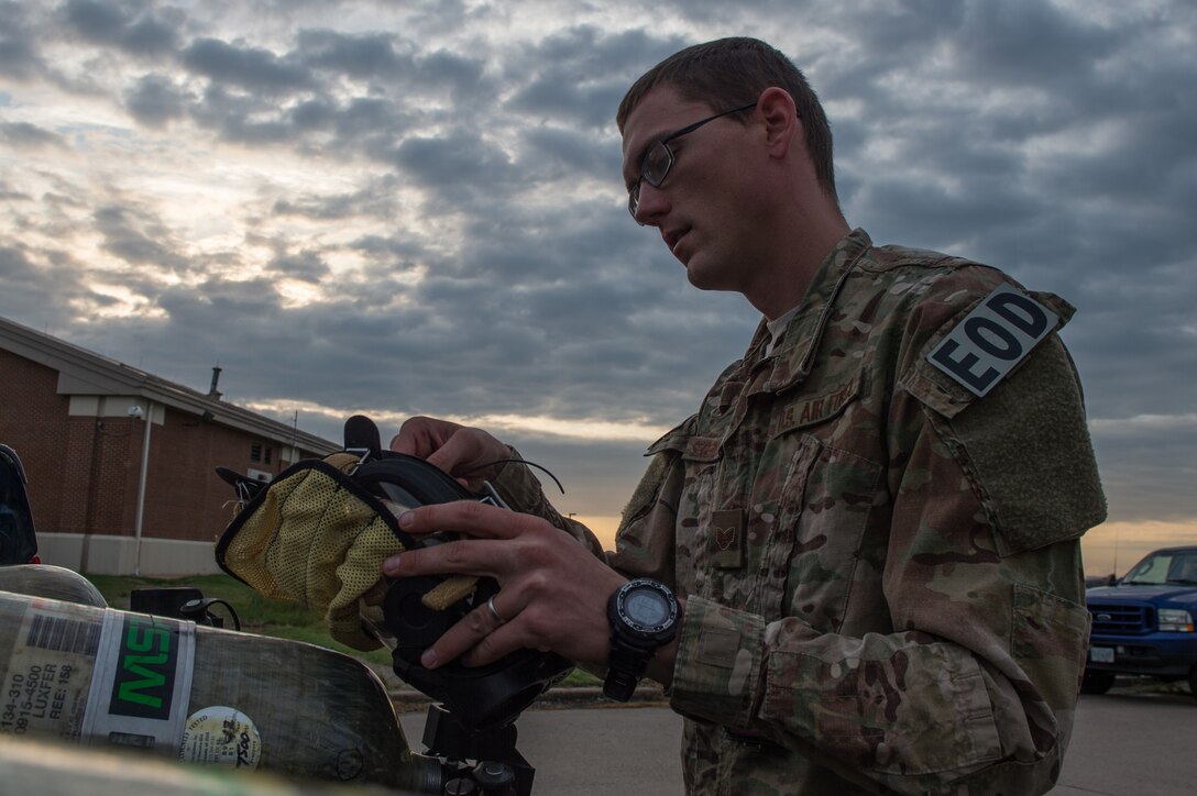 U.S. Air Force Staff Sgt.Steven Segerlund, 23rd Civil Engineer Squadron explosive ordinance disposal technician, adjusts his mask during Operation Llama Fury 3.0 at Joint Base Langley-Eustis, Va., Aug. 9, 2016.