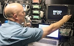 Matt Hopper, a telecommunications specialist with Task Force 51, U.S. Army North’s Contingency Command Post 1, changes the frequency on an auto control unit Aug. 9 inside the Sentinel vehicle at Kirkland Air Base in Albuquerque, New Mexico, during exercise Vigilant Guard 17-04 Aug. 3-11. The auto control unit enables operators to bridge the gap between disparate communications equipment.