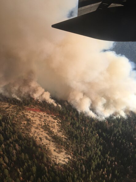 Smoke and the start of a fire retardant containment line dropped by a Modular Airborne Fire Fighting System-equipped C-130 Hercules aircraft near California’s South Fork Fire, south of Yosemite National Park are visible from MAFFS 5, Aug. 14, 2017.  Three MAFFS-equipped C-130s and aircrews from the Air Force Reserve and Air National Guard are providing support to the U.S. Forest Service fire suppression efforts from Air Tanker Base Fresno, California.   (U.S. Air Force photo/Master Sgt. Thomas Freeman)