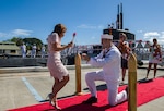 USS Jacksonville (SSN 699), proposes to his girlfriend during a homecoming arrival at Joint Base Pearl Harbor-Hickam, after completing its final deployment, Aug. 10.
