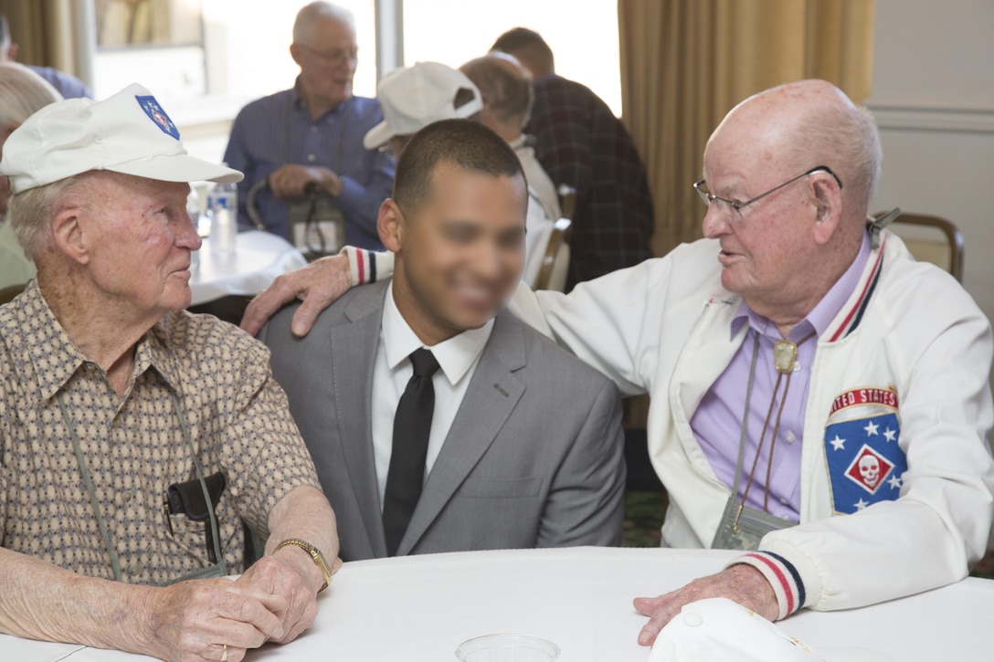 Milton Cronk and Archie B. Rackerby, World War II Raiders, talk with a current Marine Raider with 1st Marine Raider Battalion, U.S. Marine Corps Forces, Special Operations Command during the 2017 Marine Raider Association Reunion in San Diego, Aug. 11. Seventeen World War II Raiders hosted a Raider-to-Raider meeting at the San Diego Town and Country Resort, San Diego, providing an opportunity for the legends of the past to reunite with the Raiders of today and exchange stories, history, knowledge and experiences, to never lose that connection bred on the battlefield. (U.S. Marine Corps photo by Sgt. Salvador R. Moreno, released)