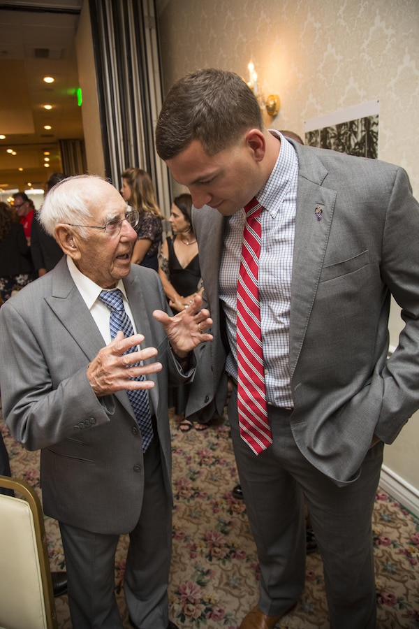 William F. Landfear, a WWII Raider, talks with a current Marine Raider with 1st Marine Raider Battalion, U.S. Marine Corps Forces, Special Operations Command during the 2017 Marine Raider Association Reunion in San Diego, Aug. 11. Seventeen World War II Raiders attended the annual event at the San Diego Town and Country Resort, San Diego, where the USMRA hosted a 1940s USO-style dinner and dance for Marine Raiders of past and present. (U.S. Marine Corps photo by Sgt. Salvador R. Moreno, released)
