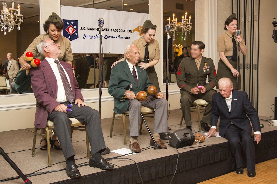 Harold S. Sheffield and Henry Kudzik, World War II Raiders, sit on the stage and participate in the entertainment portion of the evening with The Lindy Sisters during the 2017 Marine Raider Association Reunion in San Diego, Aug. 11. Seventeen World War II Raiders attended the annual event at the San Diego Town and Country Resort, San Diego, where the USMRA hosted a 1940s USO-style dinner and dance for Marine Raiders of past and present. (U.S. Marine Corps photo by Sgt. Salvador R. Moreno, released)