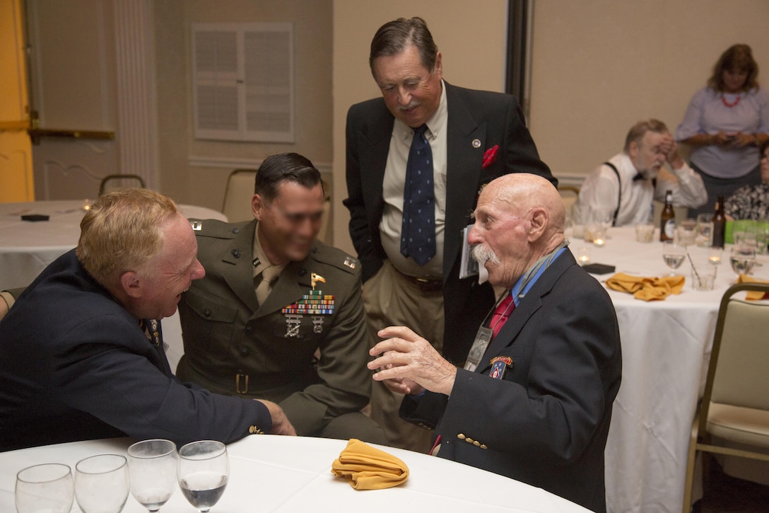 James W. Campbell, a World War II Raider, talks with a current Marine Raider with 1st Marine Raider Battalion, U.S. Marine Corps Forces, Special Operations Command during the 2017 Marine Raider Association Reunion in San Diego, Aug. 11. Seventeen World War II Raiders attended the annual event at the San Diego Town and Country Resort, San Diego, where the USMRA hosted a 1940s USO-style dinner and dance for Marine Raiders of past and present. (U.S. Marine Corps photo by Sgt. Salvador R. Moreno, released)