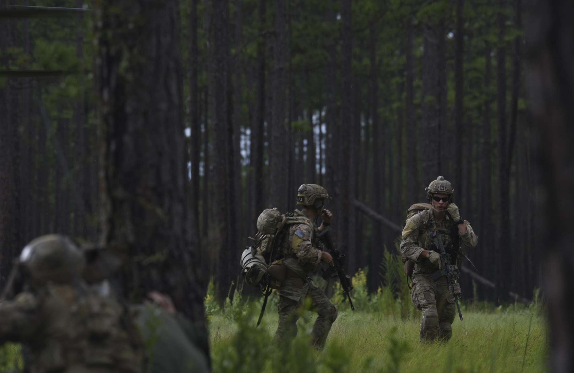 U.S. Air Force pararescuemen from Moody Air Force Base, Ga., disembark from an HH-60G Pave Hawk and begin sweeping a wooded area near Tyndall Air Force Base, Fla., for simulated hostiles during a pilot recovery mission while taking part in Stealth Guardian Aug. 8, 2017.