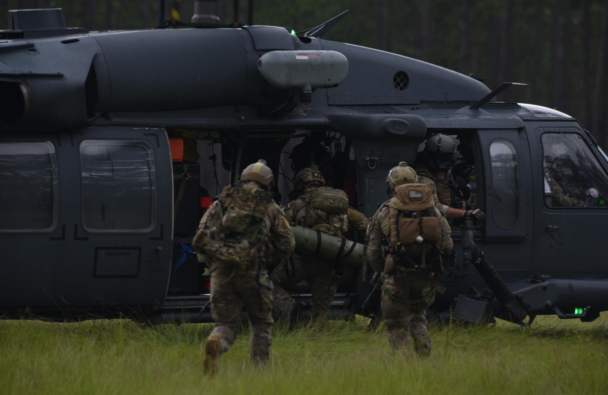 U.S. Air Force pararescuemen from Moody Air Force Base, Ga., embark into an HH-60G Pave Hawk after successfully simulating the rescue of a downed pilot from a wooded area near Tyndall Air Force Base, Fla., while taking part in exercise Stealth Guardian Aug. 8, 2017.