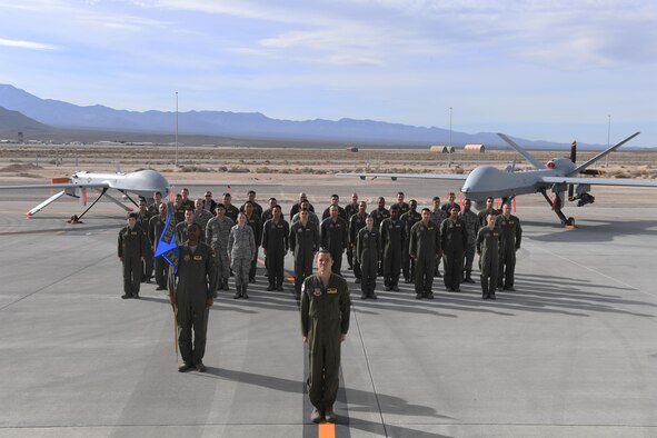 Members of the 489th Attack Squadron stand at attention during a group photo Dec. 14, 2016, at Creech Air Force Base, Nev.