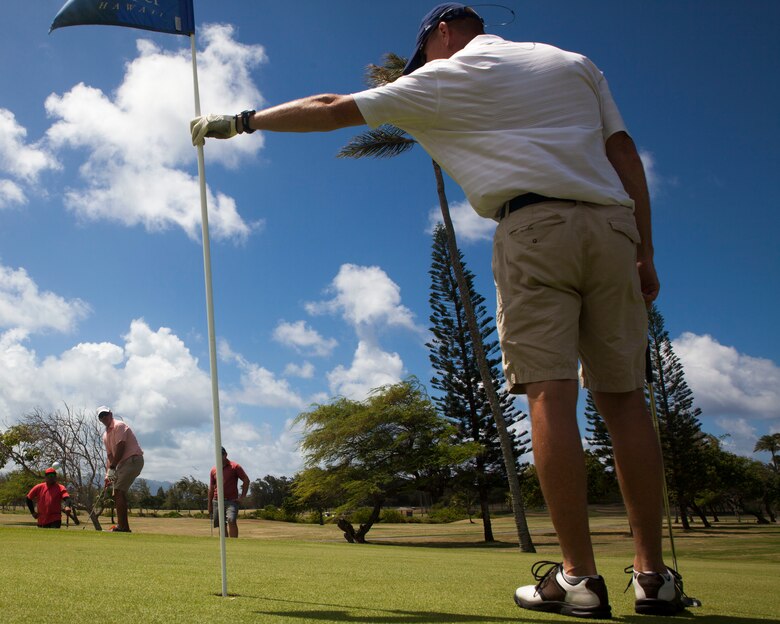Col. Michael Styskal, the commanding officer of 3rd Marine Regiment, takes a flag out of a hole during the Commander’s Cup golf tournament at the Kaneohe Klipper Golf Course, Marine Corps Base Hawaii, Aug. 11, 2017. The tournament, hosted by Marine Corps Community Services and JN Automotive Group, was open to all Service members, Department of Defense employees, civilians and guests sponsored by authorized patrons. Prizes were given out to first through eighth place contestants, and various raffles with prizes were given away. (U.S. Marine Corps photo by Lance Cpl. Matthew Kirk)