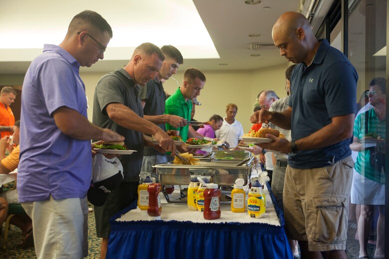 Golfers grab food upon completion of the Commander’s Cup golf tournament at the Kaneohe Klipper Golf Course aboard Marine Corps Base Hawaii on Aug. 11, 2017. The tournament, hosted by Marine Corps Community Services and JN Automotive Group, was open to all Service members, Department of Defense employees, civilians and guests sponsored by authorized patrons. Prizes were given out to first through eighth place contestants, and various raffles with prizes were given away. (U.S. Marine Corps photo by Lance Cpl. Matthew Kirk)