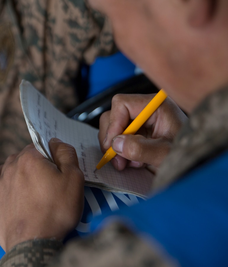 A service member in the Mongolian Armed Forces takes notes in tactical combat casualty care class during Exercise Khaan Quest 2017 at Five Hills Training Area, Mongolia, July 24, 2017. Khaan Quest 2017 is a Mongolian-hosted, combined, joint training exercise designed to strengthen the capabilities of the U.S., Mongolia and other partner nations in international peacekeeping operations. (U.S. Marine Corps photo by Lance Cpl. Charles Plouffe)