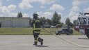 A firefighter from the 18th Civil Engineer Squadron runs a hose towards the egress training area during annual hands-on fire training August 14, 2017, at Kadena Air Base, Japan. Okinawan firefighters and members of the 18th CES keep Team Kadena and Okinawa safe by learning to work together. (U.S. Air Force photo/ Airman 1st Class Greg Erwin)