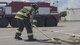 A firefighter from the 18th Civil Engineer Squadron straightens out a hose during annual hands-on fire training August 14, 2017, at Kadena Air Base, Japan. Okinawan firefighters and members of the 18th CES keep Team Kadena and Okinawa safe by learning to work together. (U.S. Air Force photo/ Airman 1st Class Greg Erwin)