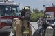 U.S. Air Force Senior Airman Keith Brown, 18th Civil Engineer Squadron firefighter, makes final checks to his partner’s equipment during annual hands-on fire training August 14, 2017, at Kadena Air Base, Japan. Okinawan firefighters and members of the 18th CES keep Team Kadena and Okinawa safe by learning to work together. (U.S. Air Force photo/ Airman 1st Class Greg Erwin)