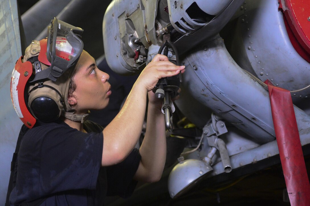 Navy Petty Officer 3rd Class Brandi Handley tightens a safety wire.