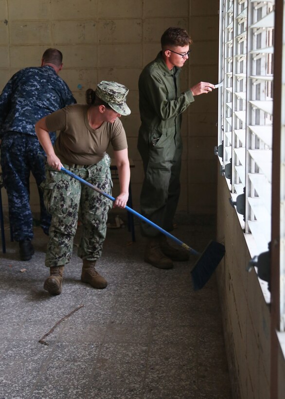 U.S. military service members clean and chip paint during a Southern Partnership Station 17 community relations project at a Honduran elementary school