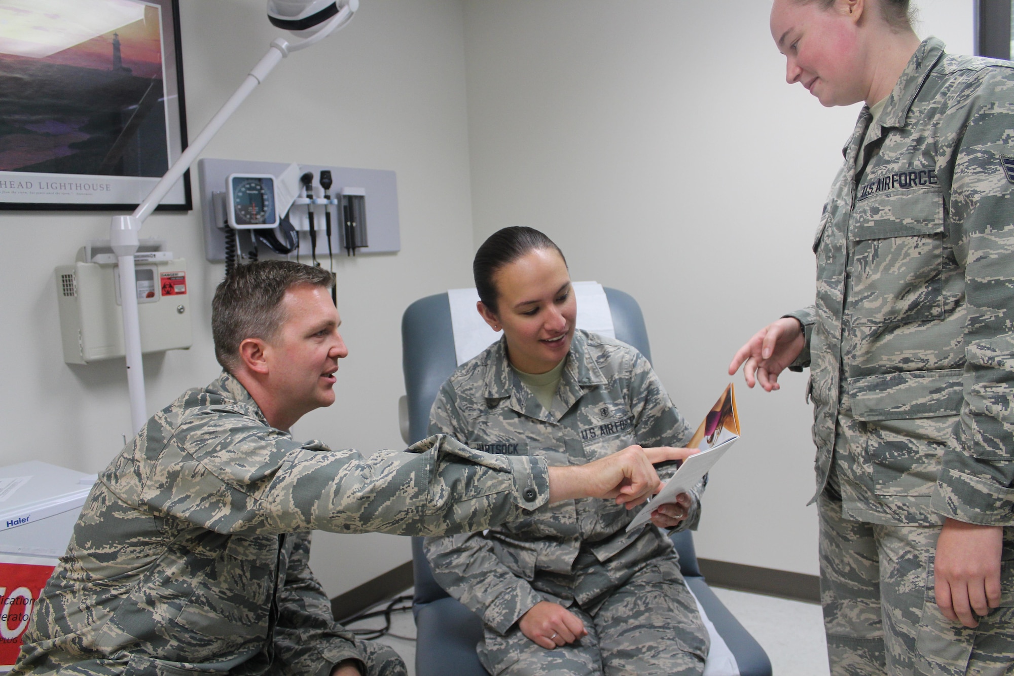 Maj. Justin Fox, 88th Medical Group plastic surgeon, and medical technician Senior Airman Leah Borland, discuss plastic surgery options with Airman 1st Class Brittany Hartsock (middle). The 88th Medical Group plastic surgery clinic’s primary mission is to provide reconstructive procedures but also offers cosmetic procedures. (U.S. Air Force Photo/Stacey Geiger)