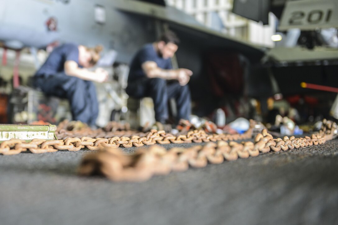 Sailors take a break after chain inventory.