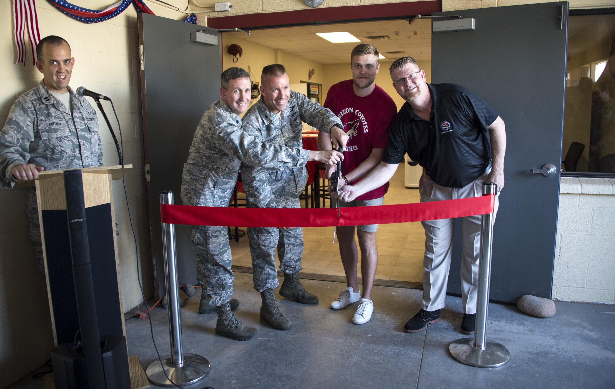 Brig. Gen. Brooke Leonard, 56th Fighter Wing commander, and Kevin Connauton, Arizona Coyotes hockey player, cut the ribbon with members of the Luke community at the Spiritual Maintenance Center on Luke Air Force Base, Ariz. Aug. 15, 2017. The Spiritual Maintenance Center was a place established for Airmen to become spiritually and physically strengthened through fellowship and mentorship from fellow Airmen. (U.S. Air Force photo/Airman 1st Class Alexander Cook)