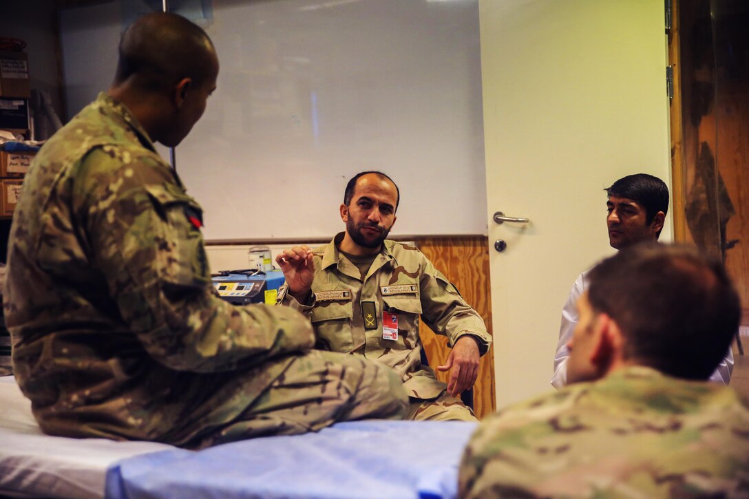 Soldiers assigned to the 2nd Forward Surgical Team, U.S. Forces-Afghanistan discuss various surgical procedures.