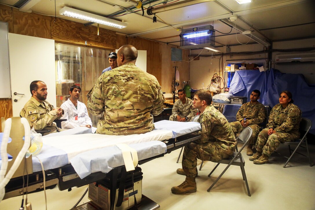 Soldiers assigned to the 2nd Forward Surgical Team, U.S. Forces-Afghanistan discuss various surgical procedures.