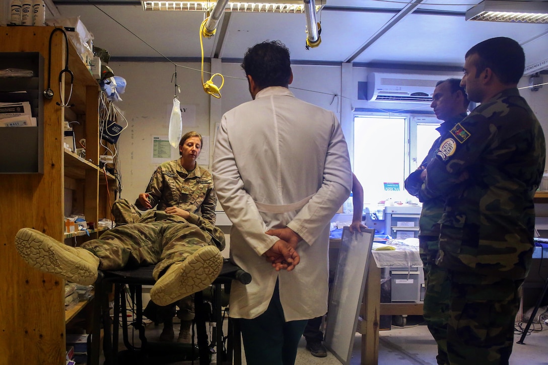 A soldier assigned to the 2nd Forward Surgical Team, U.S. Forces-Afghanistan, demonstrates proper head trauma treatment.