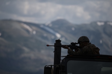 U.S. Marine Lance Cpl. Luis Mejia, a motor transportation operator with Combat Logistics Battalion 5, Combat Logistics Regiment 1, 1st Marine Logistics Group, posts security while participating in a convoy during Mountain Training Exercise 4-17 at Mountain Warfare Training Center, August 6, 2017. Marines participating in the Mountain Training Exercise post security to demonstrate protecting various areas against any possible simulated attack or ambush in the mountainous terrain. (U.S. Marine Corps photo by Lance Cpl. Timothy Shoemaker)