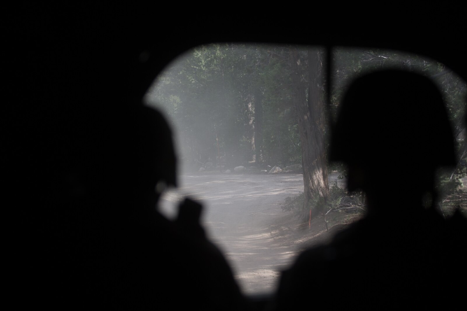 U.S. Marines with Combat Logistics Battalion 5, Combat Logistics Regiment 1, 1st Marine Logistics Group, posts for security in the rear of the convoy during Mountain Training Exercise 4-17 at Mountain Warfare Training Center, August 6, 2017. Marines in the last vehicle of the convoy posts security in case of enemy contact to the rear. (U.S. Marine Corps photo by Lance Cpl. Timothy Shoemaker)