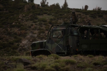 U.S. Marines and Sailors with Combat Logistics Battalion 5, Combat Logistics Regiment 1, 1st Marine Logistics Group, participate in a convoy during Mountain War Training 4-17 at Mountain Warfare Training Center, August 5, 2017. Most 7-ton vehicles have a Marine Rifleman positioned on top of the roof to act as an observer. (U.S. Marine Corps photo by Lance Cpl. Timothy Shoemaker)