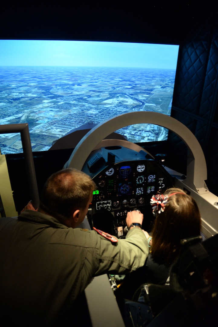 Airmen with the 559th Flying Training Squadron welcomed younger family members to Hangar 64 on Joint Base San Antonio-Randolph for Bring Your Child to Work Day August. 11.