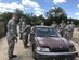 Maxwell Airmen take a look at a vehicle used as a prop for improvised explosive device identification training during BEAST week at basic military training at Joint Base San Antonio-Lackland, Texas, July 27-28, 2017. Airmen from Maxwell Air Force Base, Ala., accompanied 42nd Air Base Wing Commander Col. Eric Shafa, where he was the reviewing official for a BMT graduation. (US Air Force photo/Capt. Amber Bullard)