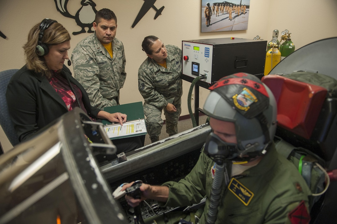 An airman uses a device that monitors vital signs.