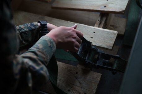 U.S. Marine Pfc. Olivia Rutherford, an ammunition technician with Combat Logistics Battalion 5, Combat Logistics Regiment 1, 1st Marine Logistics Group, uses a strap to tie down ammunition during Mountain Training Exercise 4-17 at Marine Corps Mountain Warfare Training Center, August 3, 2017. An ammo technician works in every aspect of the ammunition field, including receipt, storage, issue, and handling of ammunition and toxic chemicals. (U.S. Marine Corps photo by Lance Cpl. Timothy Shoemaker)