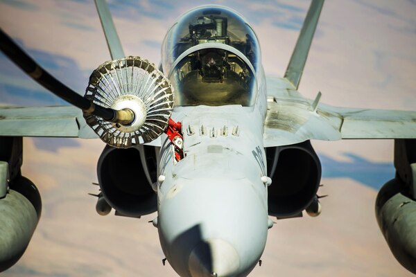 A Navy F-18 Growler receives fuel from an Air Force KC-10 Extender during a mission supporting Operation Inherent Resolve over Syria, Aug. 4, 2017. The F-18 is an airborne electronic attack aircraft providing support to coalition partners fighting  the Islamic State of Iraq and Syria in Southwest Asia. Air Force photo by Staff Sgt. Trevor T. McBride