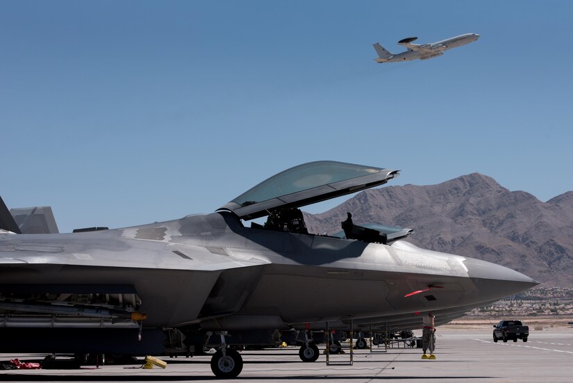 An E-3 Sentry takes off from Nellis Air Force Base, Nev., behind an F-22 Raptor from the 94th Fighter Squadron during Red Flag 17-4, Aug. 14, 2017.  Red Flag is a realistic combat training exercise involving the air, space and cyber forces of the United States and its allies. (U.S. Air Force photo/Staff Sgt. Carlin Leslie)