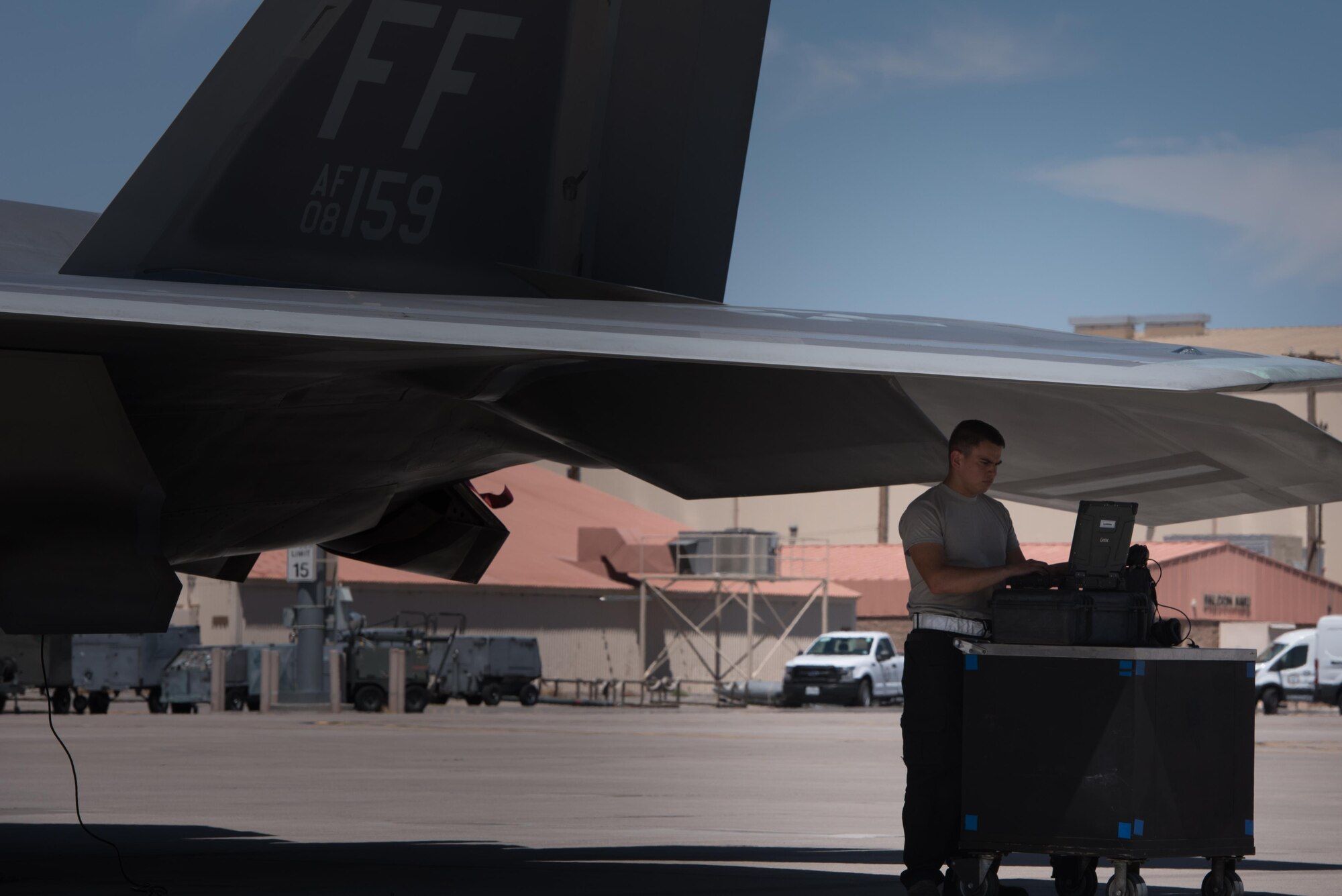 U.S. Air Force Airman Juan Luna, 94th Aircraft Maintenance Unit crew chief, reviews technical orders, while preparing to launch an F-22 Raptor during Red Flag 17-4, at Nellis Air Force Base, Nev. , Aug. 14, 2017. (U.S. Air Force photo/Staff Sgt. Carlin Leslie)