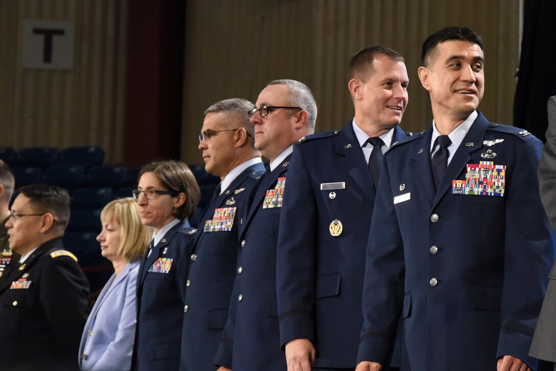 After arriving on stage U.S. Air Force Col. Ricky Mills, 17th Training Wing commander, and Col. Jeffrey Sorrell, 17th Training Wing vice commander, take a moment to greet the other guests of the annual convocation of the San Angelo Independent School District at the Foster Communications Colosseum, San Angelo, Texas, Aug. 15, 2017.